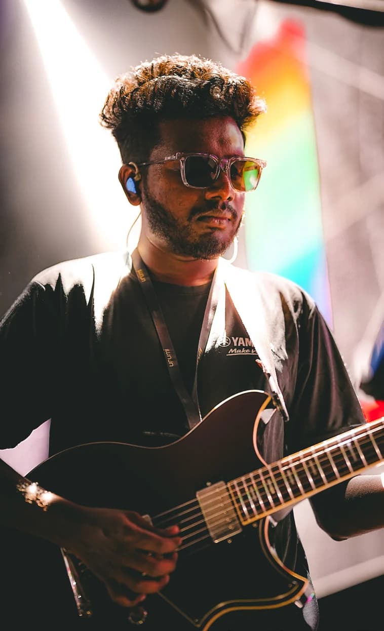 Kiran Raj playing electric guitar on stage