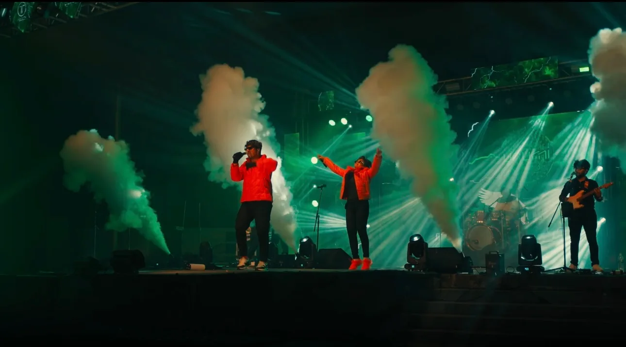A wide view of Urumi performing between columns of stage smoke