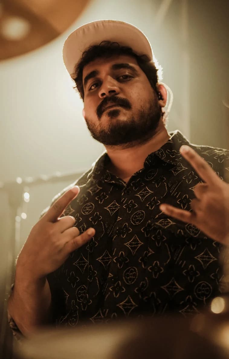 Nithin Joseph wearing a cap and patterned shirt